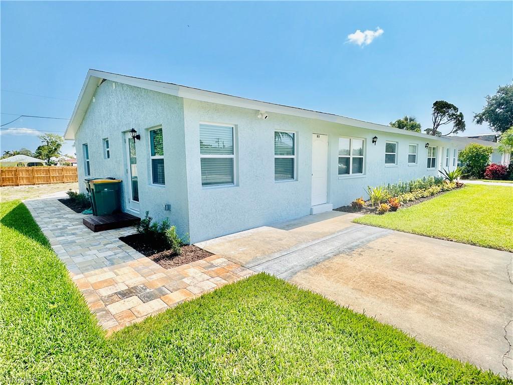 Single story home featuring a front lawn and a patio