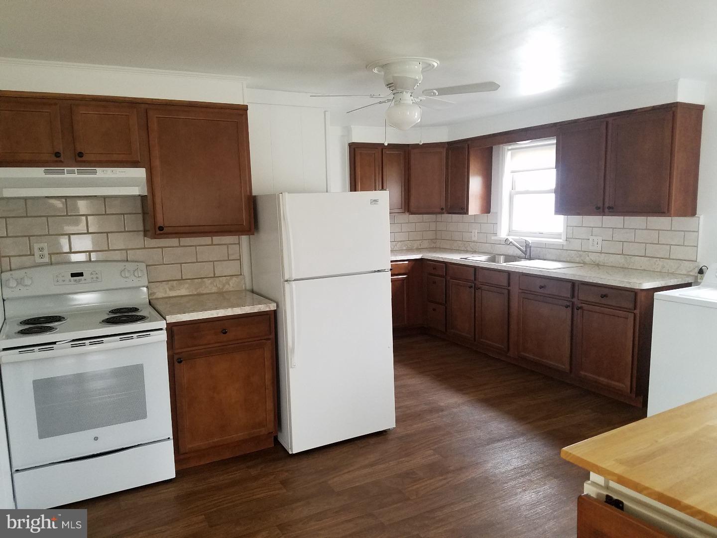 a kitchen with a stove a sink and a refrigerator