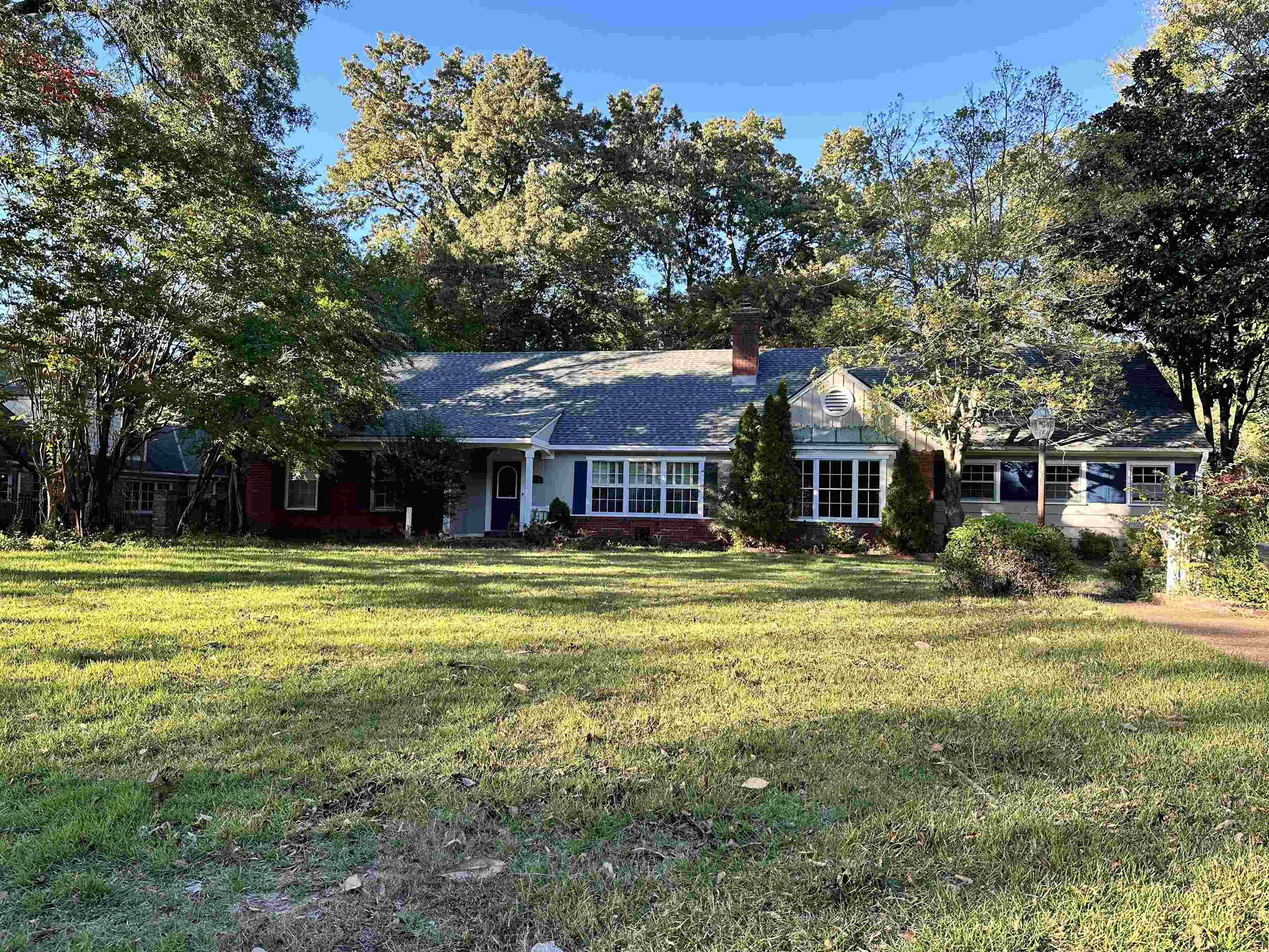 a front view of a house with a big yard