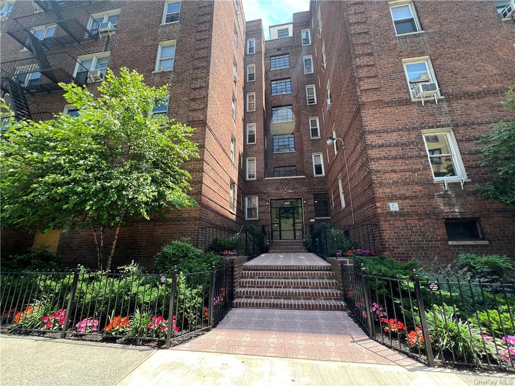 a front view of a multi story building with yard