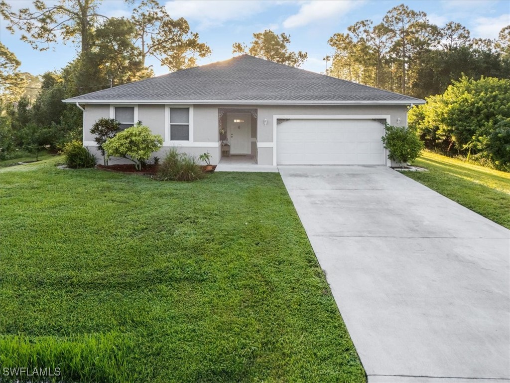 a front view of house with yard and green space