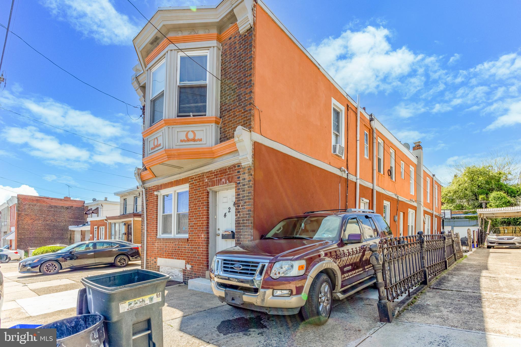 a front view of a building with parking space