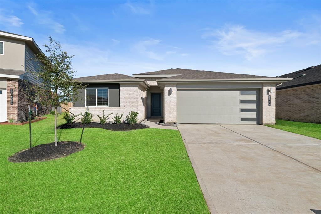 a front view of house with a garden