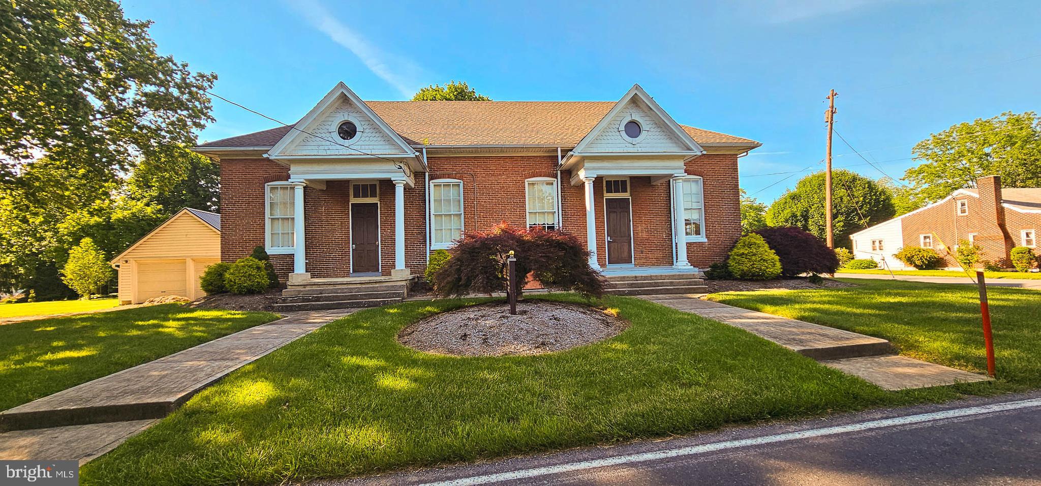 a front view of a house with garden