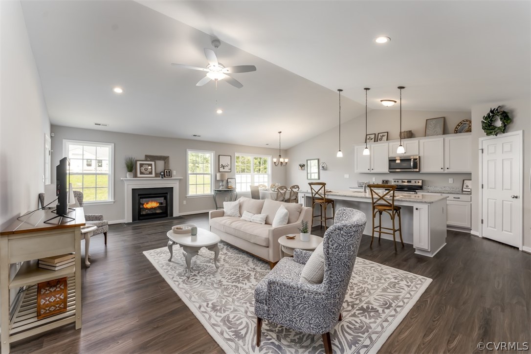 a living room with fireplace furniture and a wooden floor