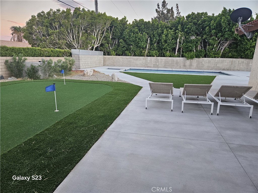 a view of a garden with an outdoor seating