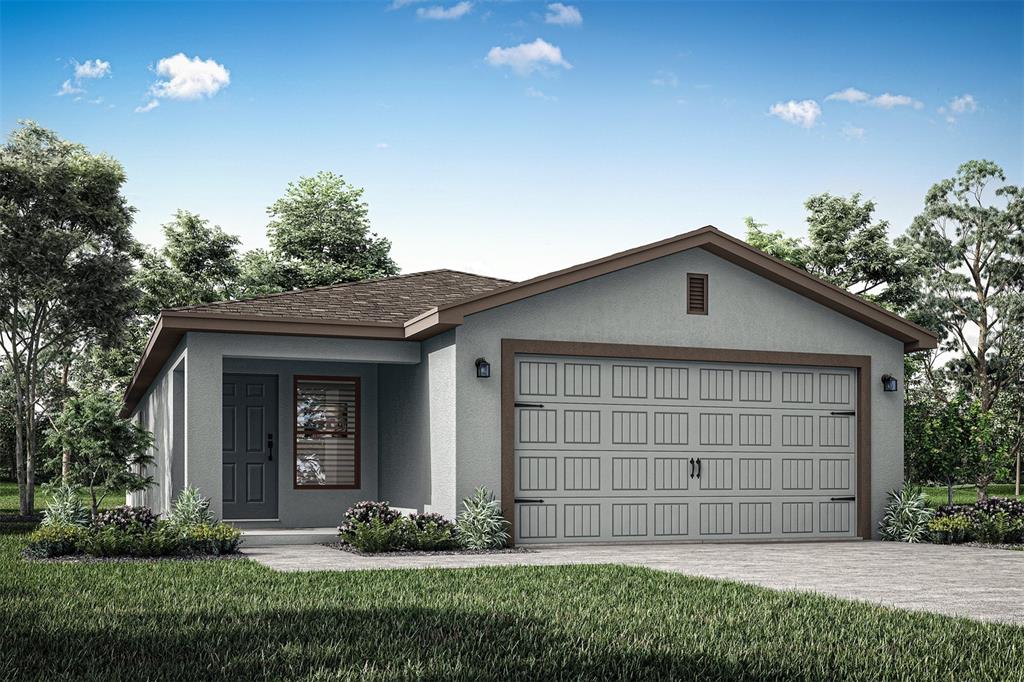 a front view of a house with a yard and garage