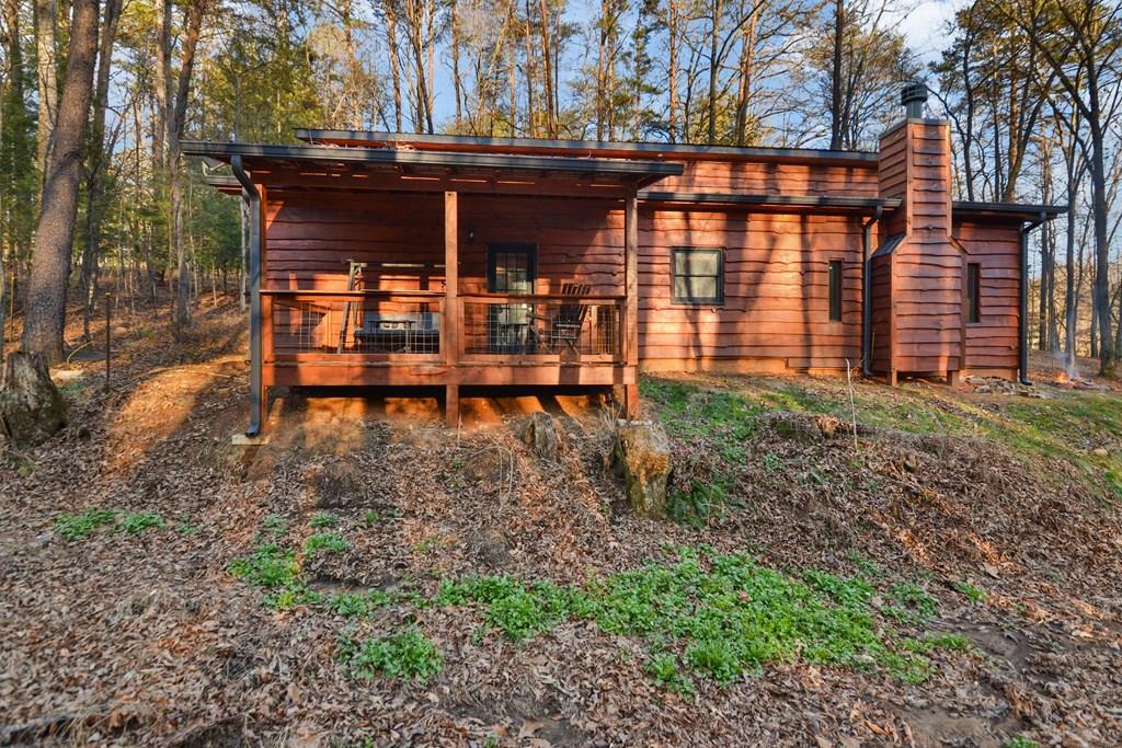 a backyard of a house with table and chairs