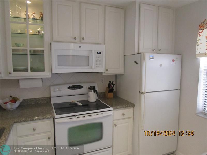 a white refrigerator freezer sitting inside of a kitchen