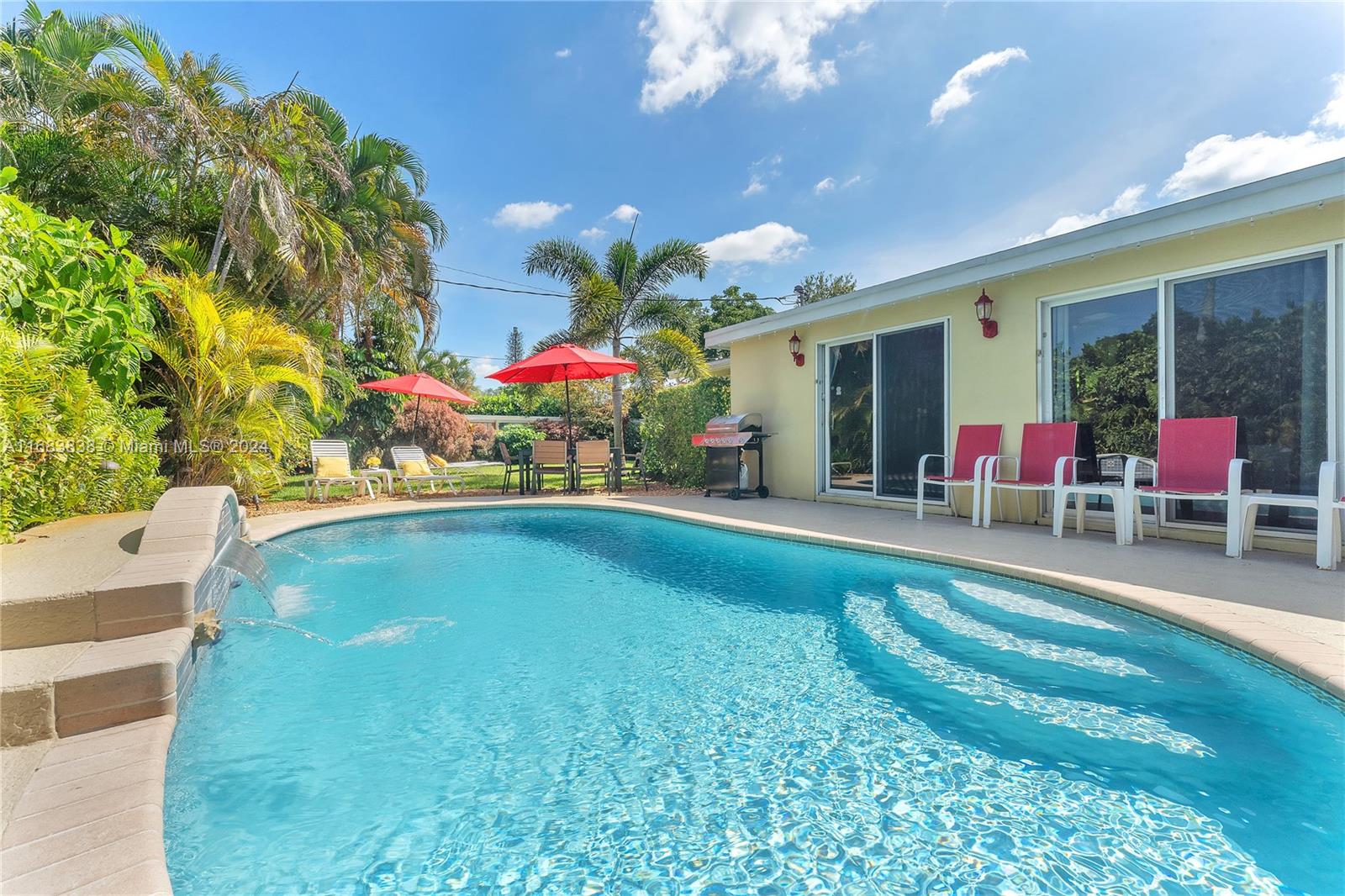 an outdoor space with swimming pool and furniture