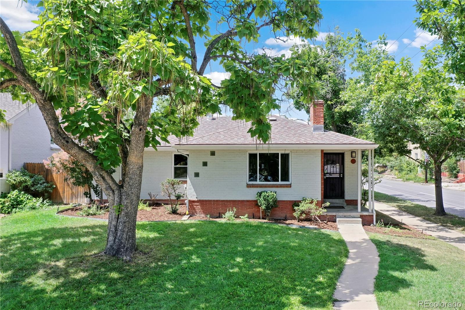 a front view of house with yard and outdoor seating