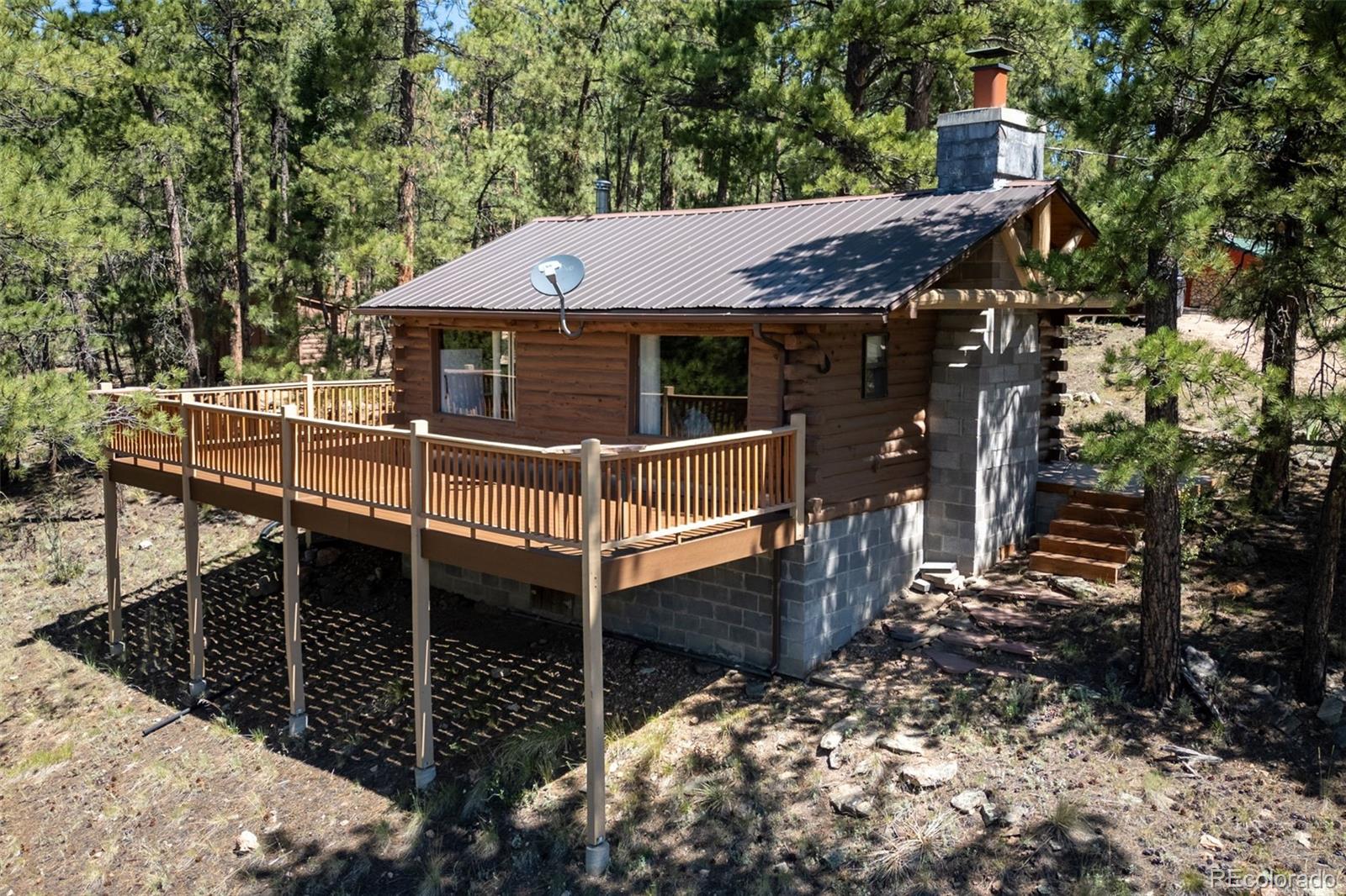 a view of house with wooden fence and trees