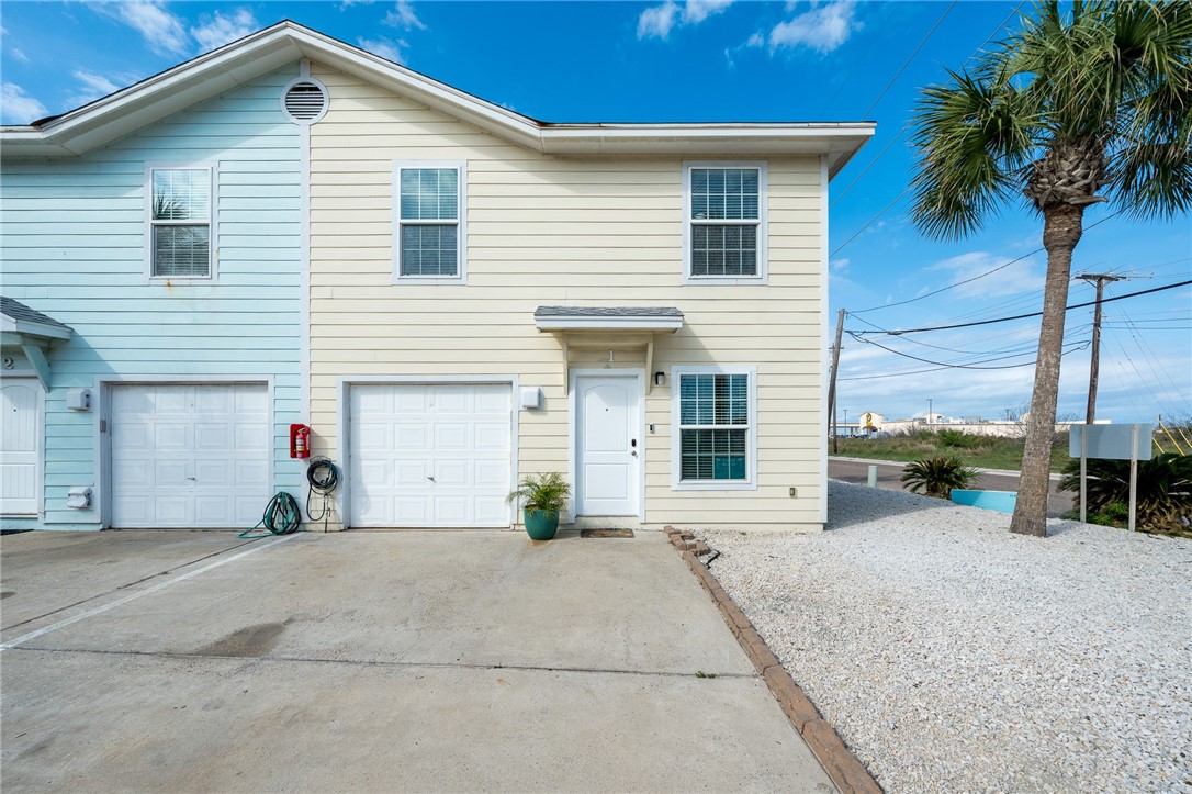 a view of a house with a yard and garage