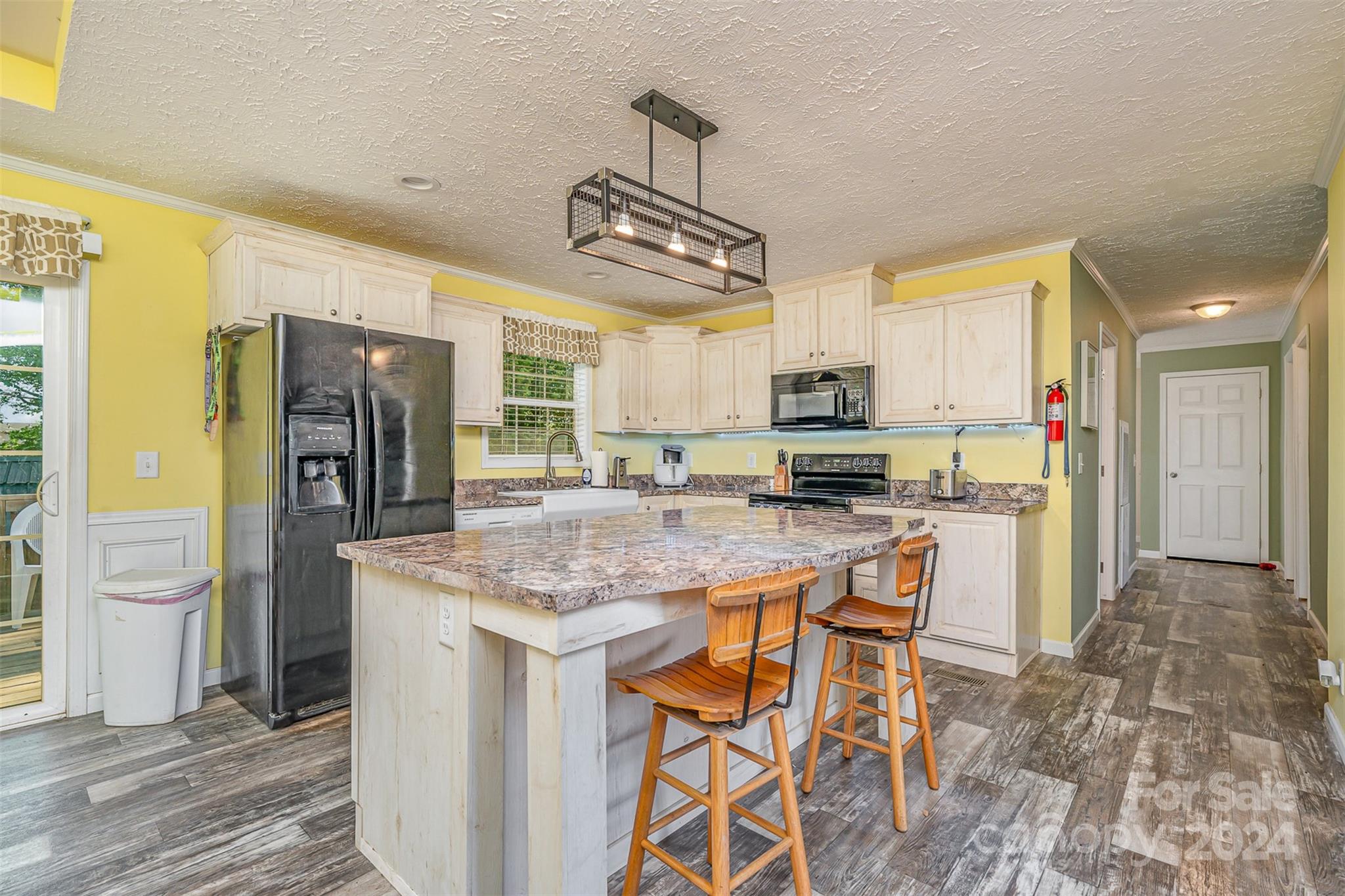 a kitchen with stainless steel appliances granite countertop a sink and a refrigerator