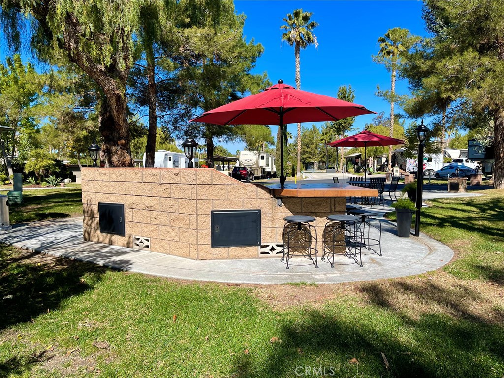 a view of a patio with a table and chairs under an umbrella