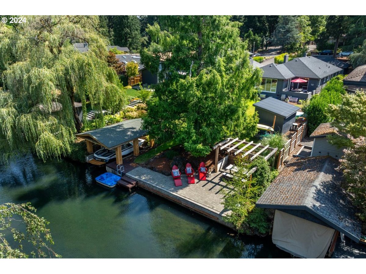 an aerial view of a house with a garden and lake view