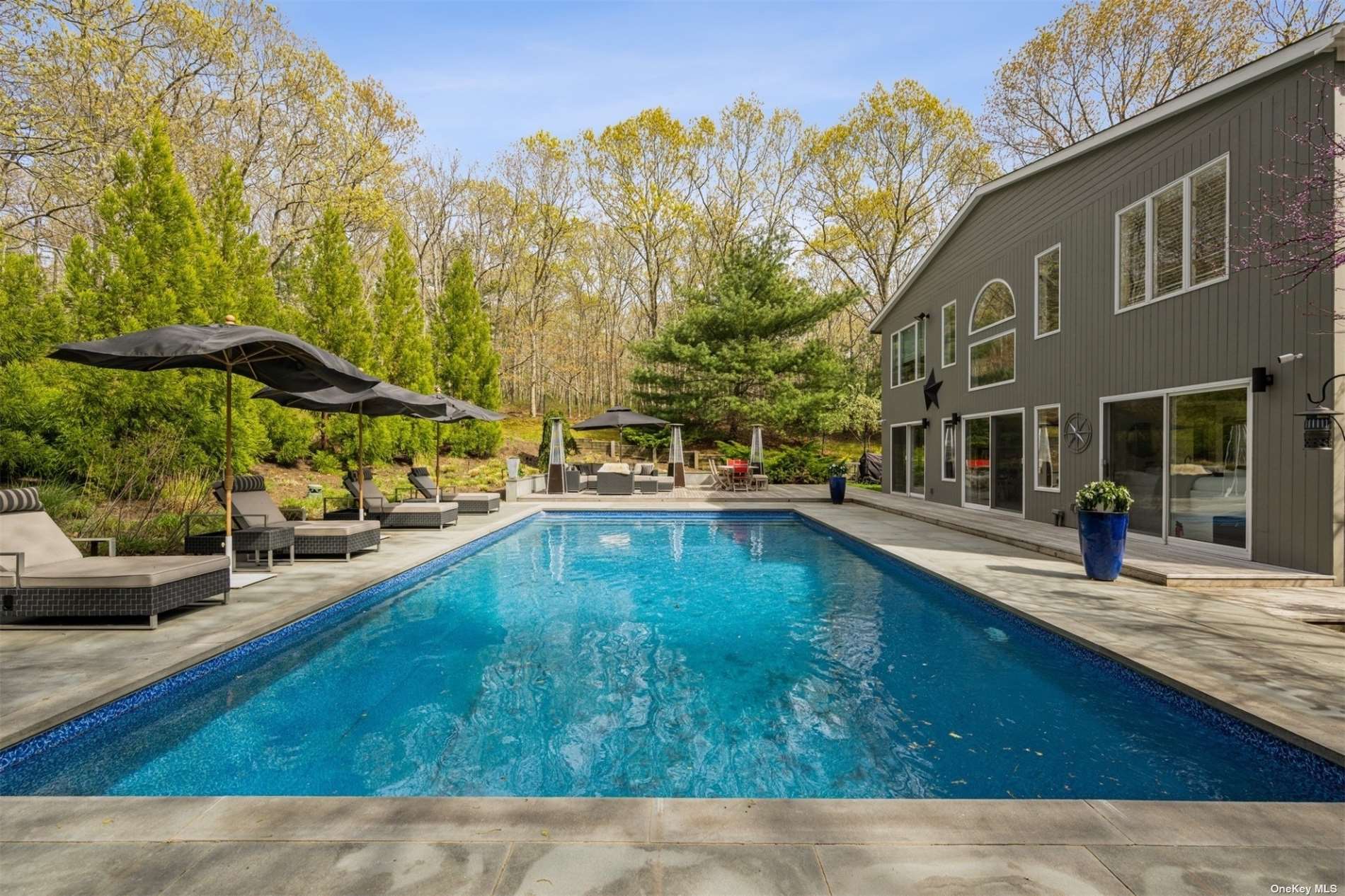 a swimming pool view with a outdoor seating