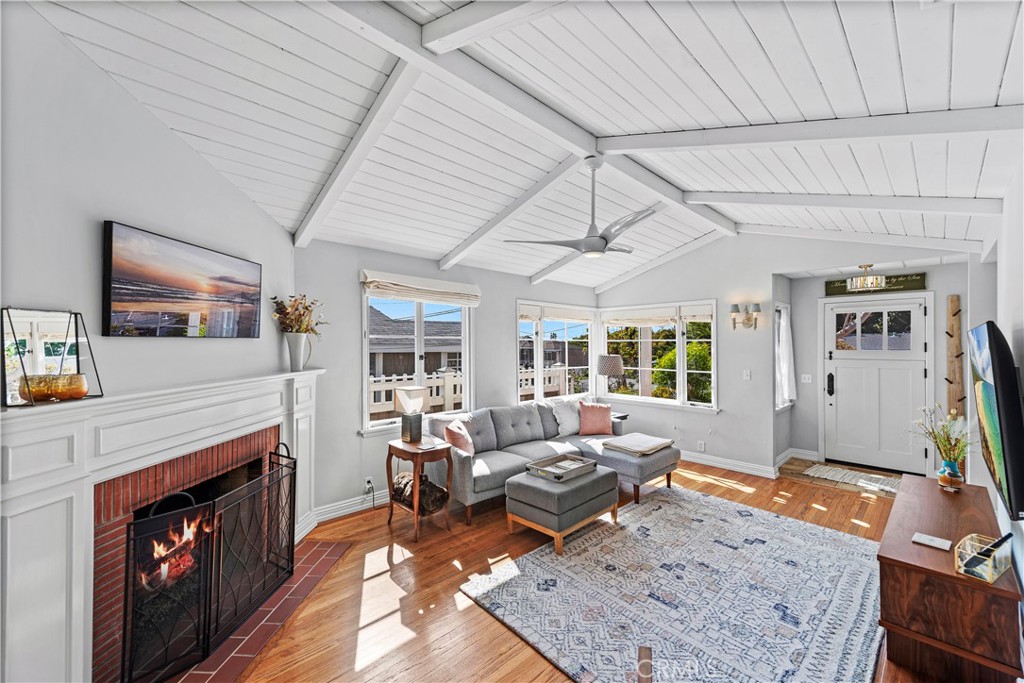 a living room with furniture a flat screen tv and a fireplace