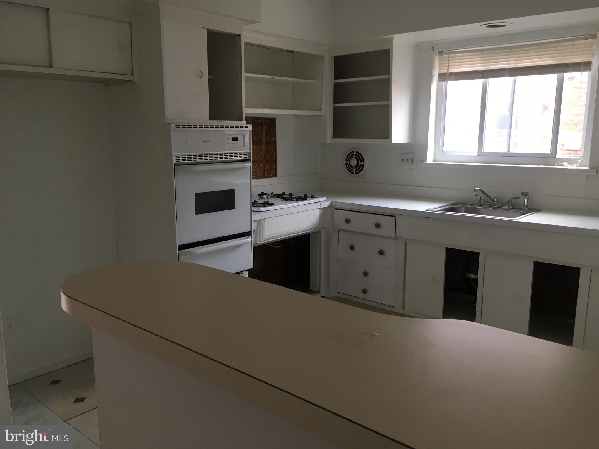 a kitchen with a stove and a sink