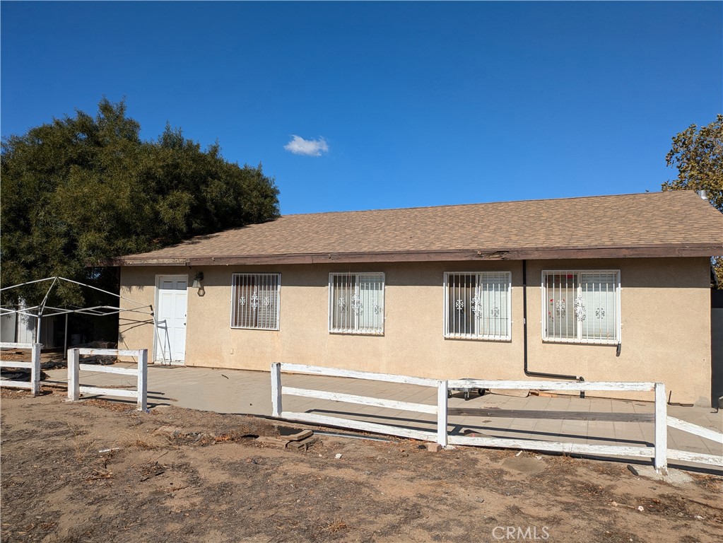 a view of a house with a fence and a window