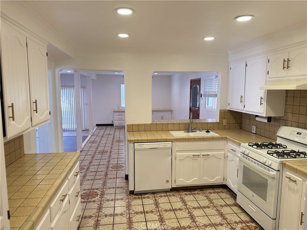 a kitchen with a sink stove and cabinets