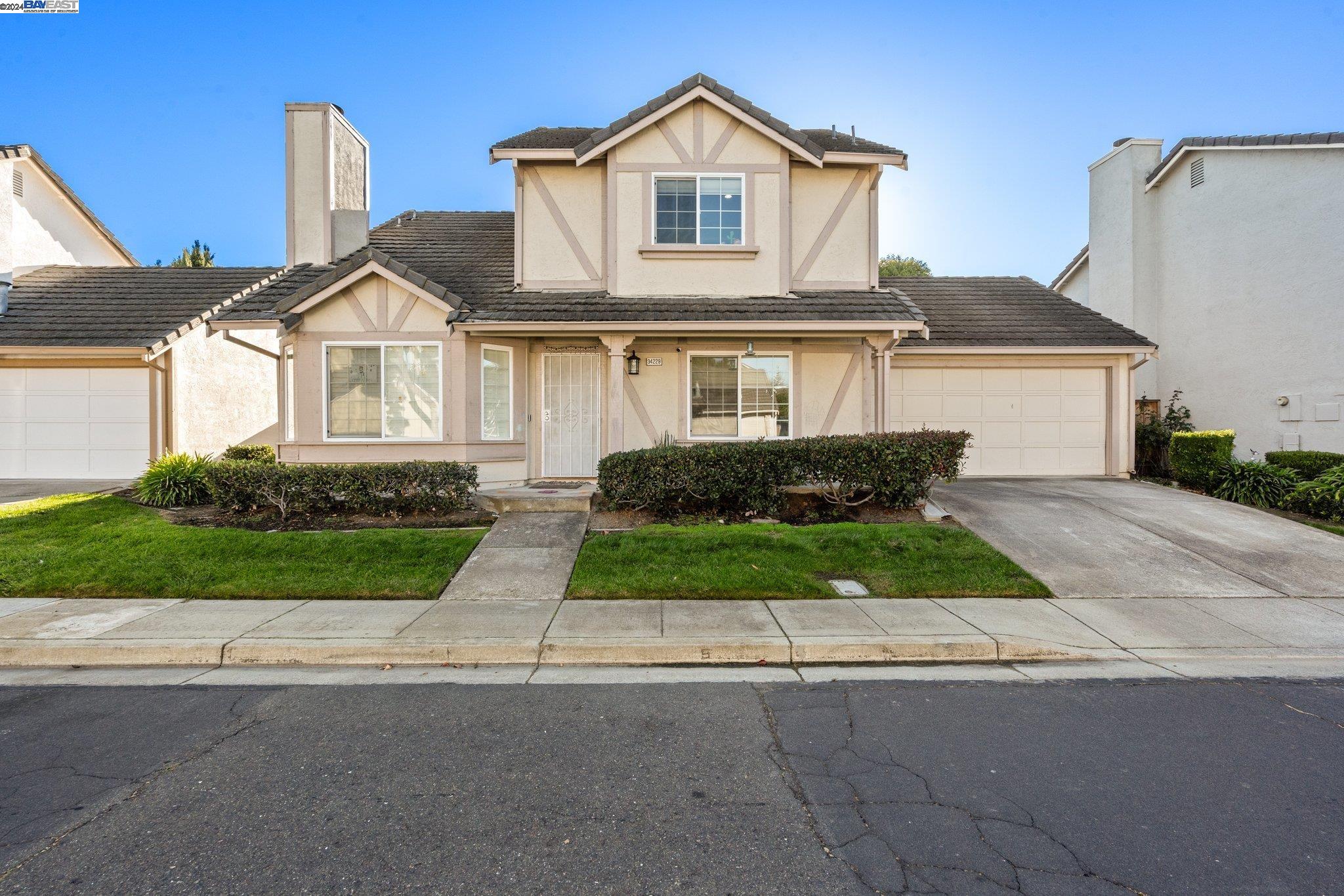 a front view of a house with a yard and garage