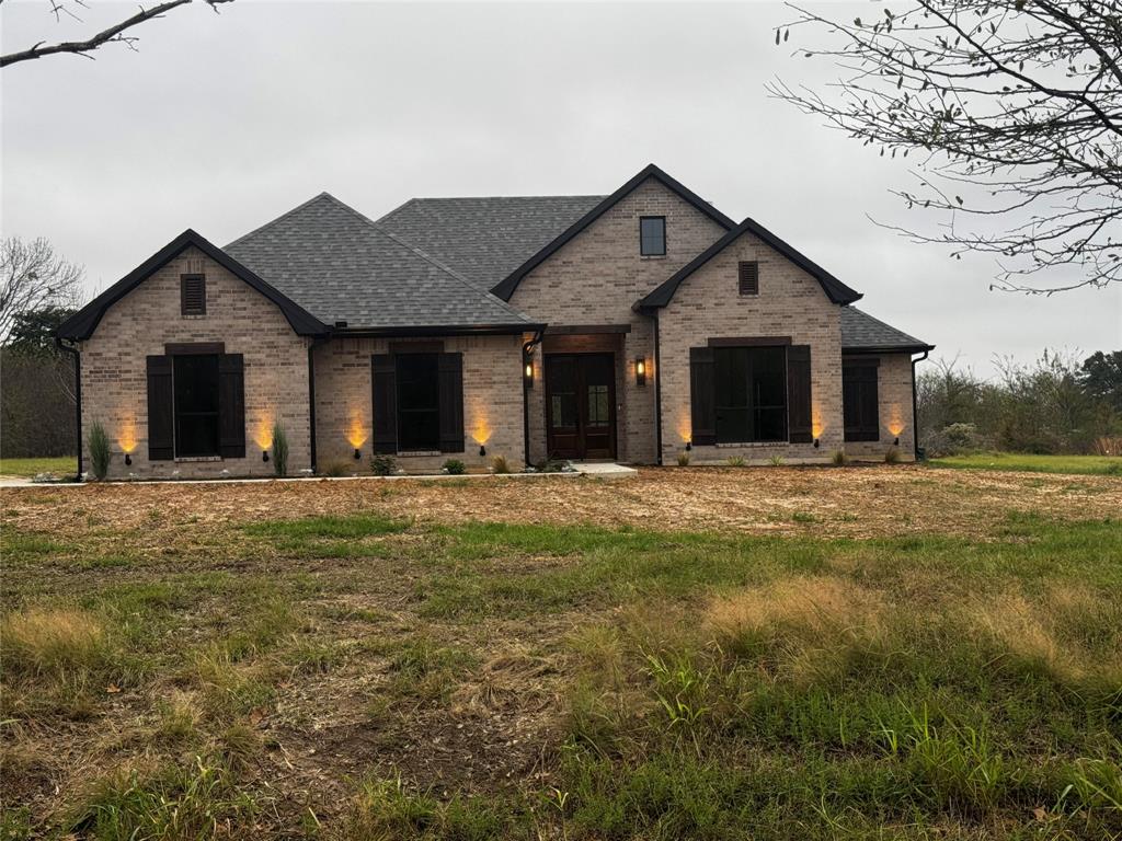 a view of a house with a yard