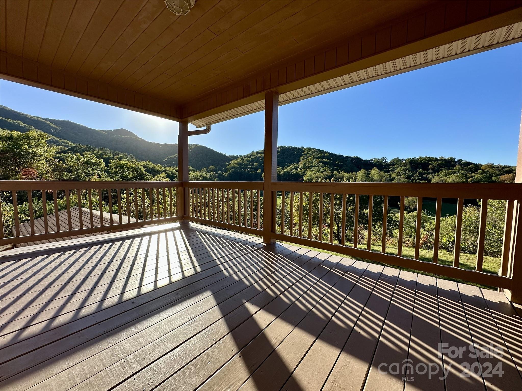 a view of balcony with wooden floor