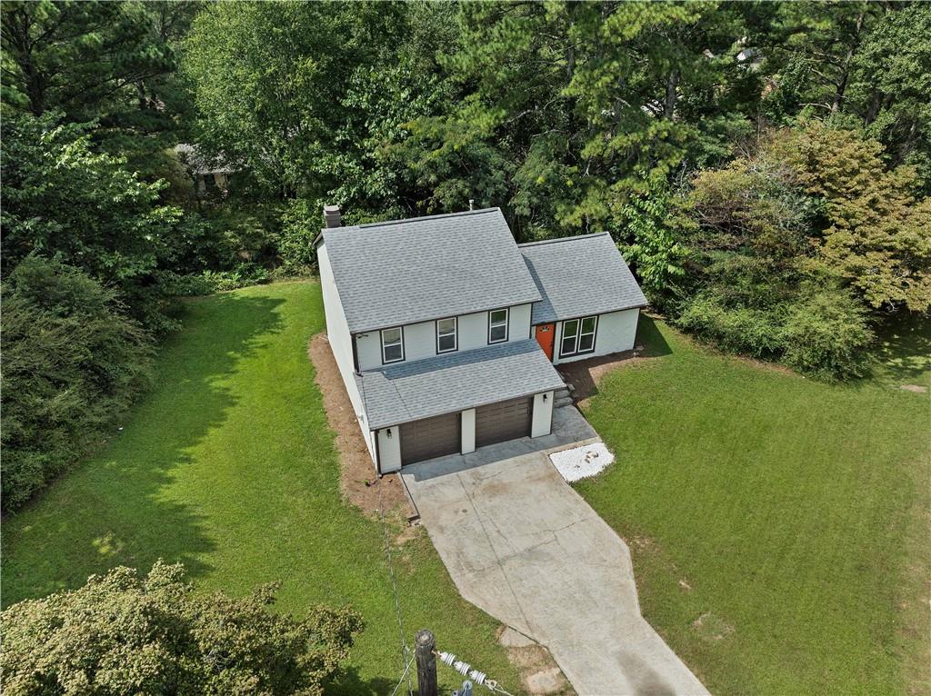 an aerial view of a house with a yard