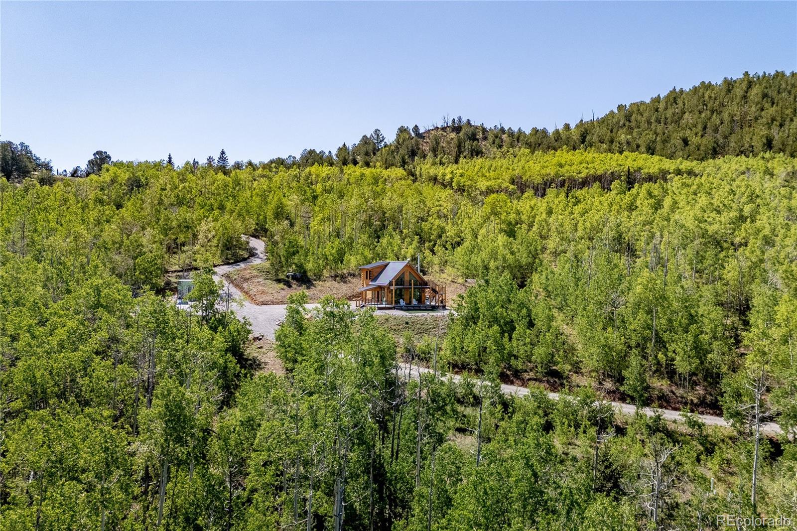 a backyard of a house with lots of green space and mountain view in back