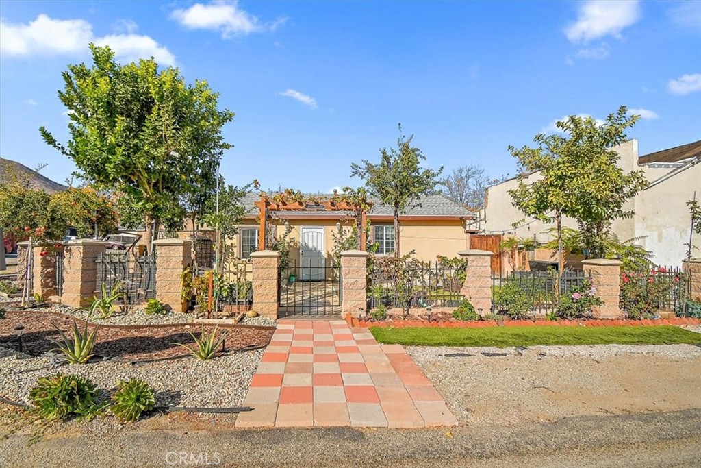 a front view of a house with a garden