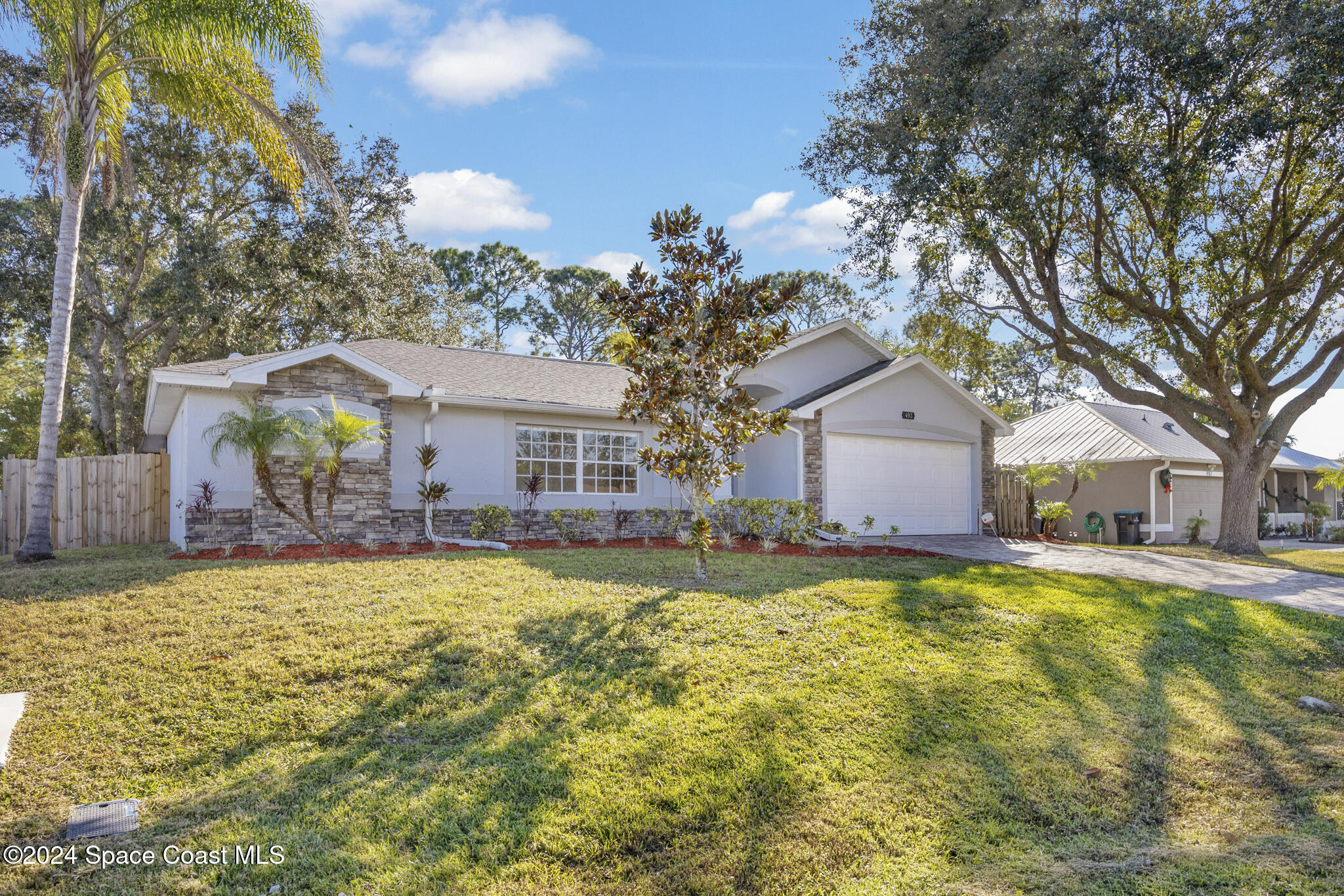 a view of a house with a yard and tree s