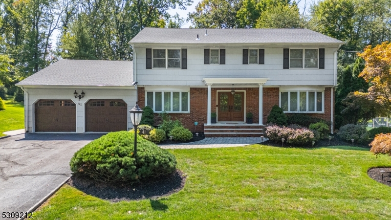 a front view of a house with garden and porch