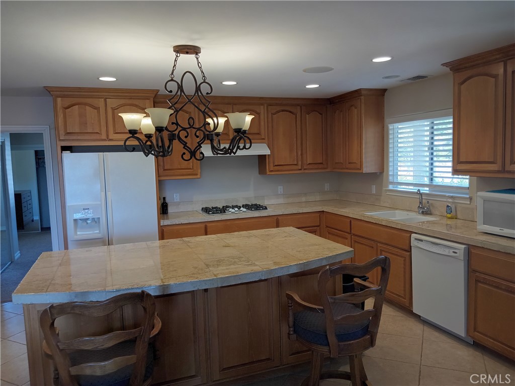 a kitchen with a table chairs sink and window