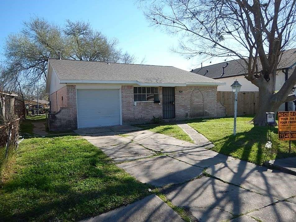 a house that has a tree in front of it