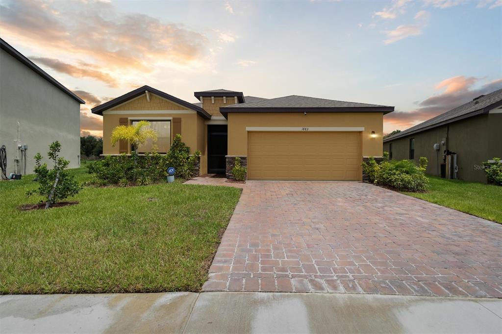 a front view of a house with a yard and garage