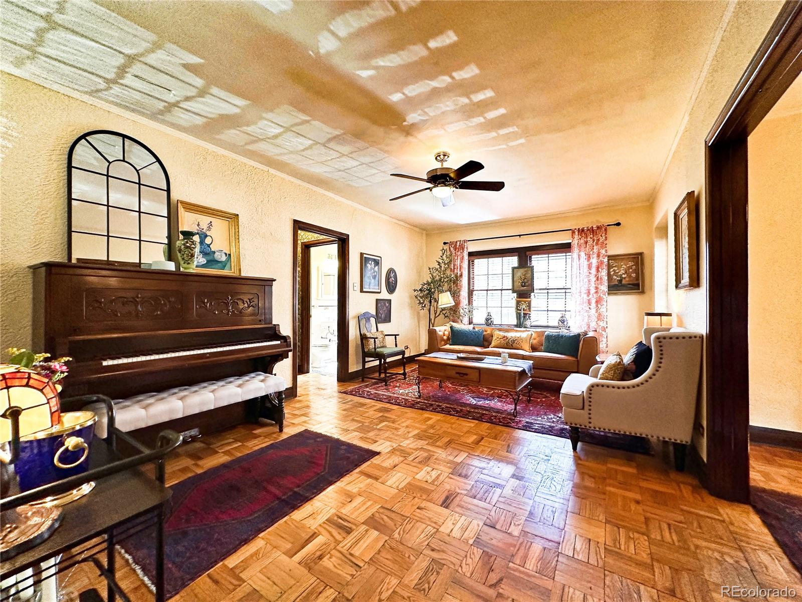 a living room with furniture a rug and a window