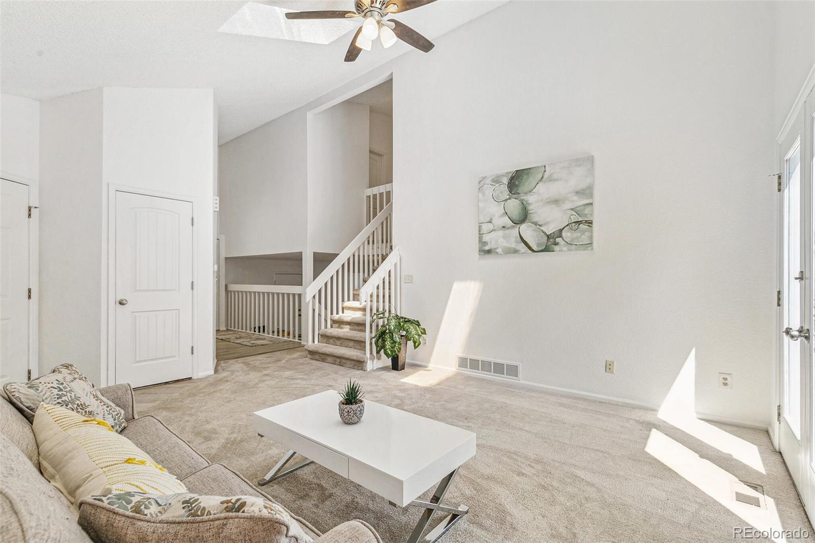 a living room with furniture and white walls