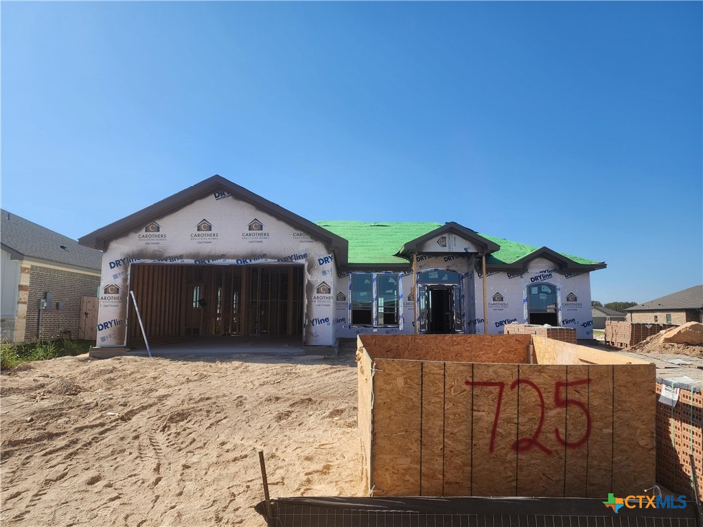 a view of a house with wooden fence