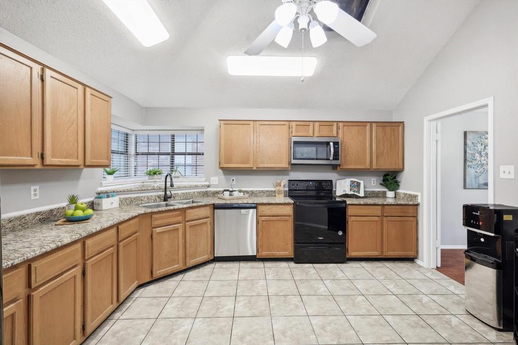 a kitchen with a sink stove and microwave