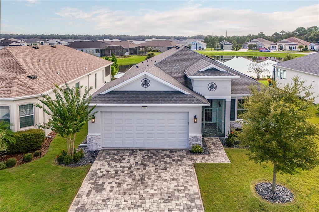 an aerial view of a house with a yard