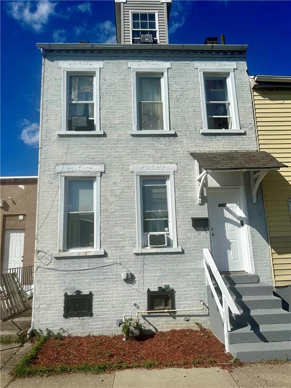 a front view of a house with stairs