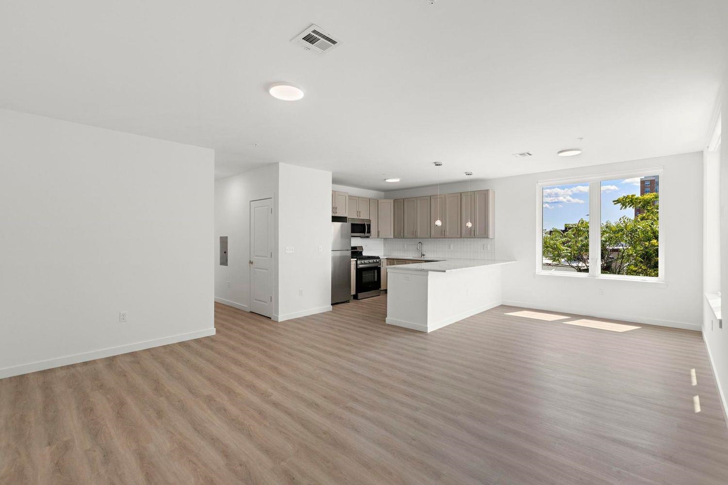 a view of kitchen with wooden floor and electronic appliances