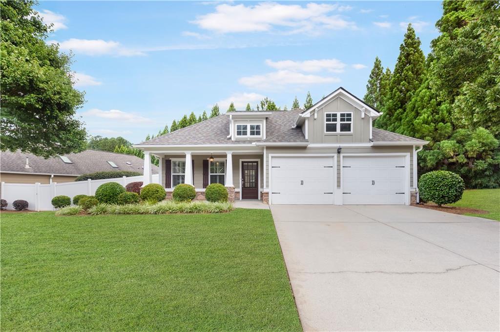 a front view of house with yard and green space