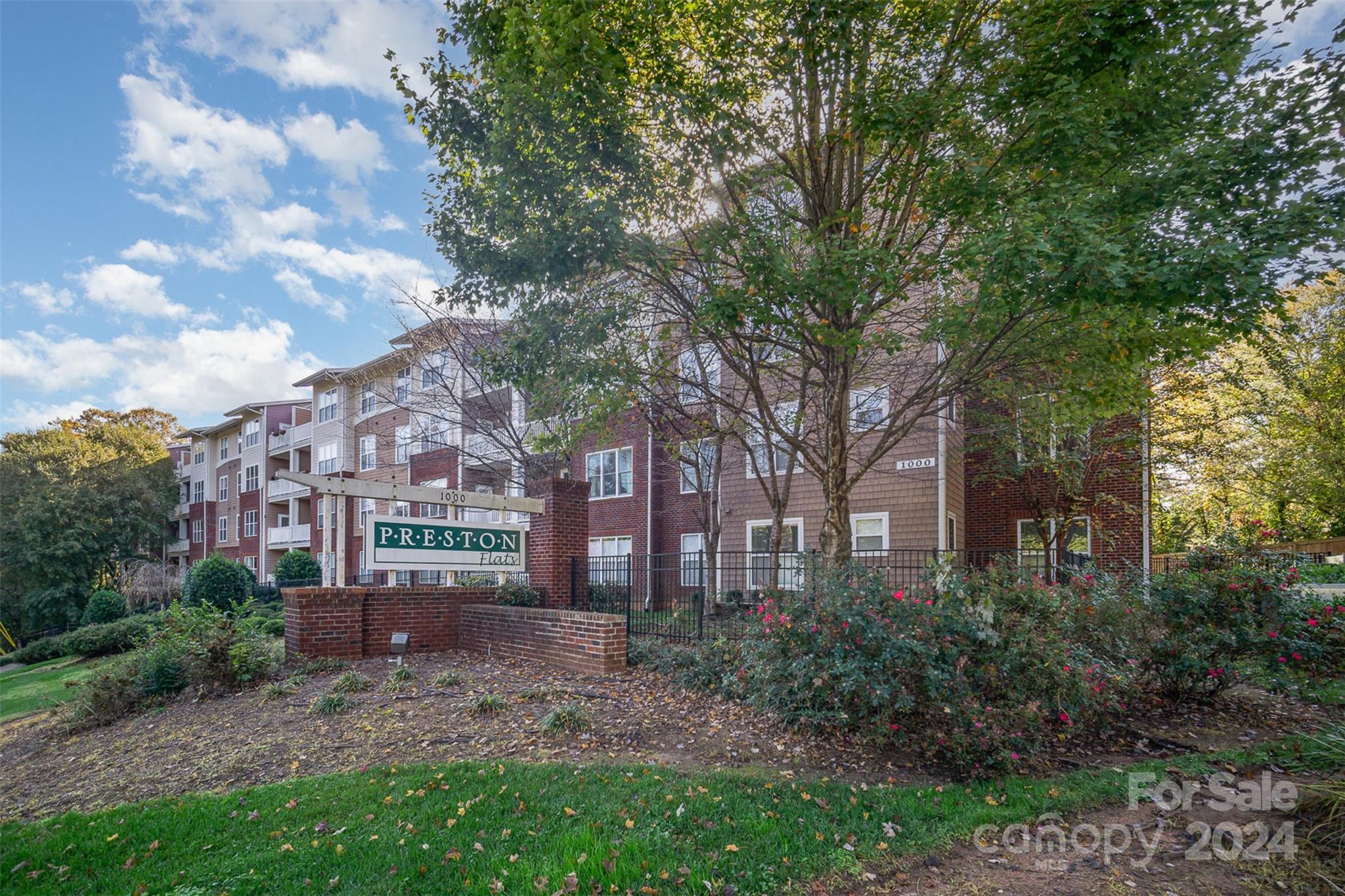 a view of a big yard in front of a brick building