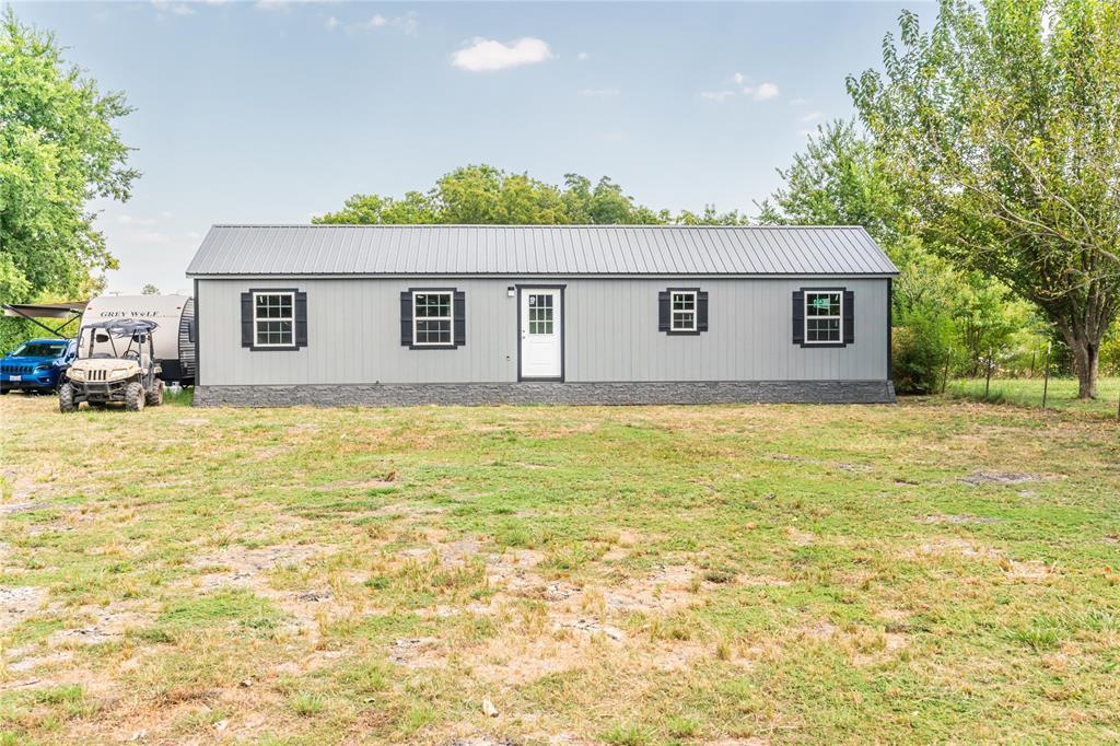 a view of house that has a yard