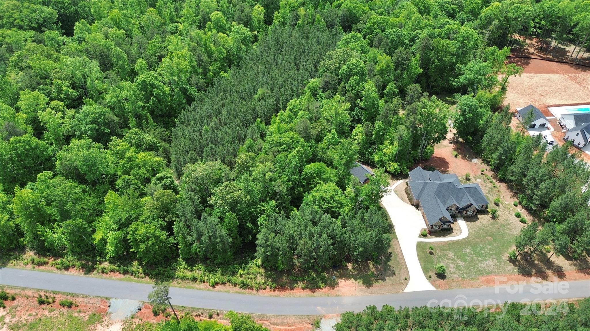 an aerial view of a house with yard