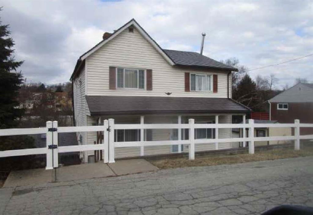 a front view of a house with a large window