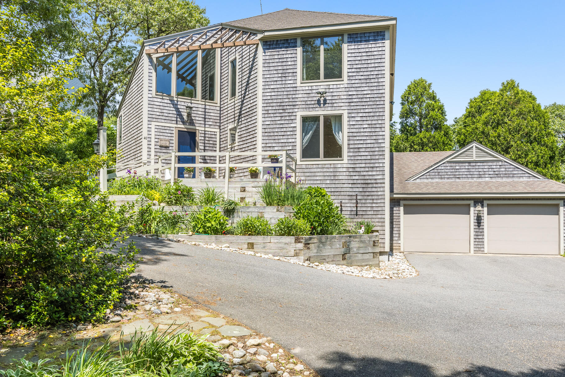 a front view of a house with a yard and a garage