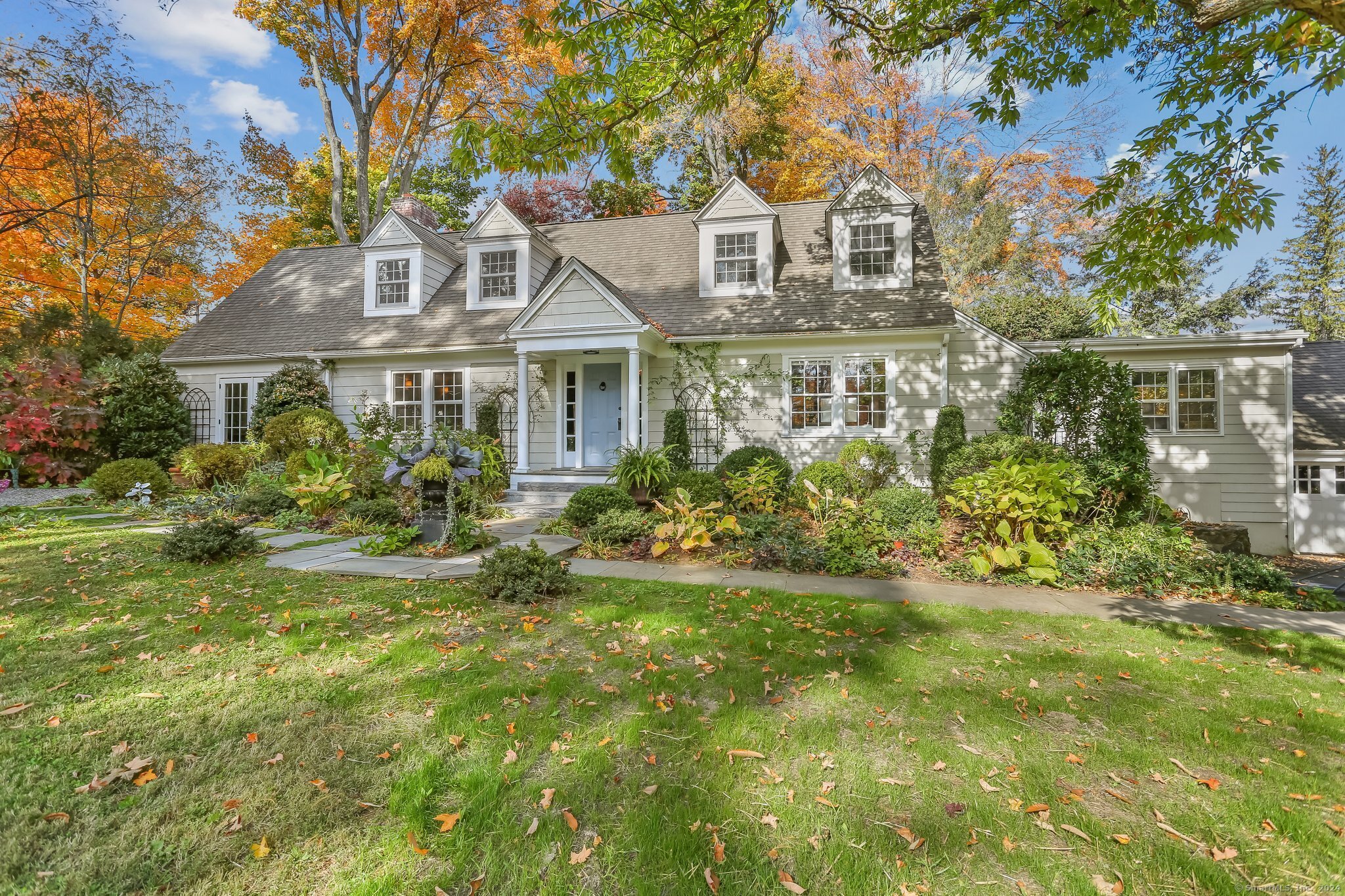 a front view of a house with a garden